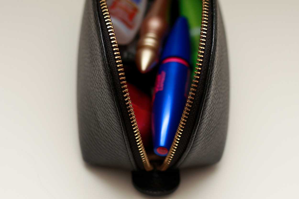 A close up of the side of the makeup bag from the Leather Travel Case Set from Cuyana
