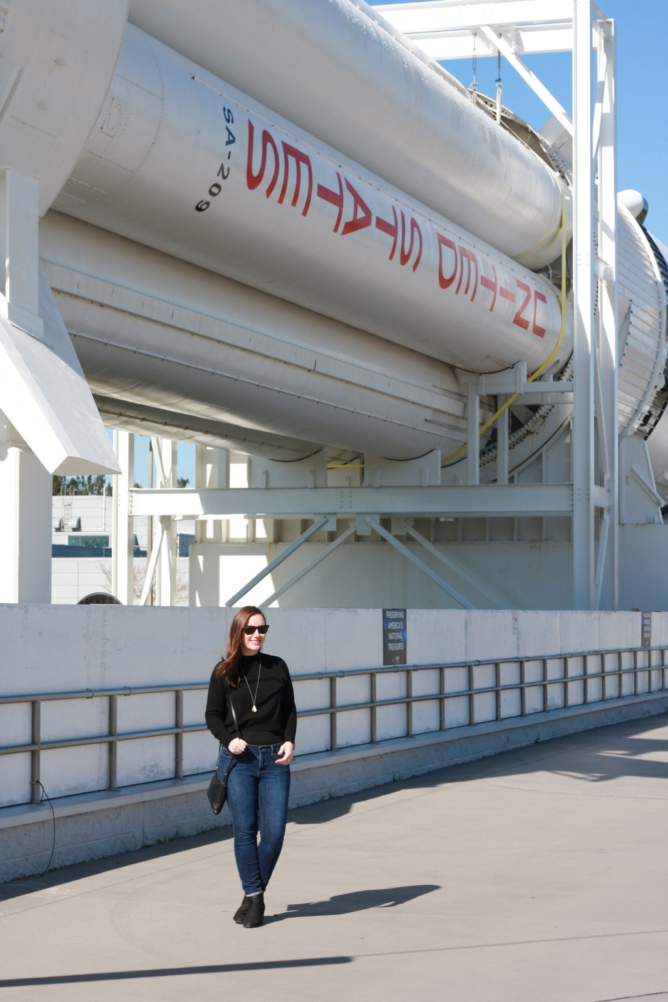 Alyssa stands in front of a rocket at the Kennedy Space Center