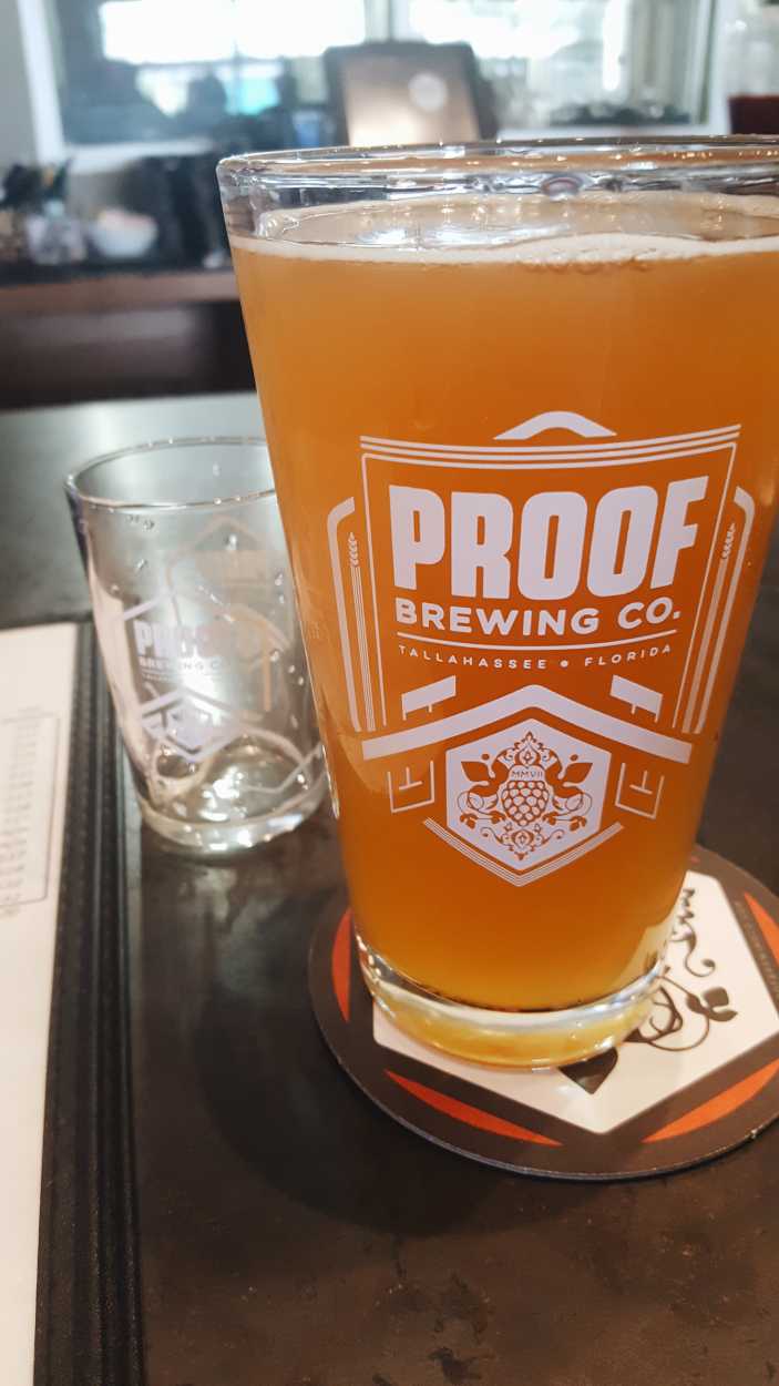 A pint of beer in a glass from Proof Brewing Co.