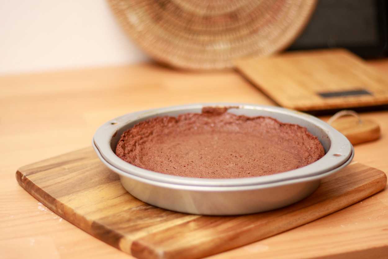 A Kladdkaka cools on a wooden paddle
