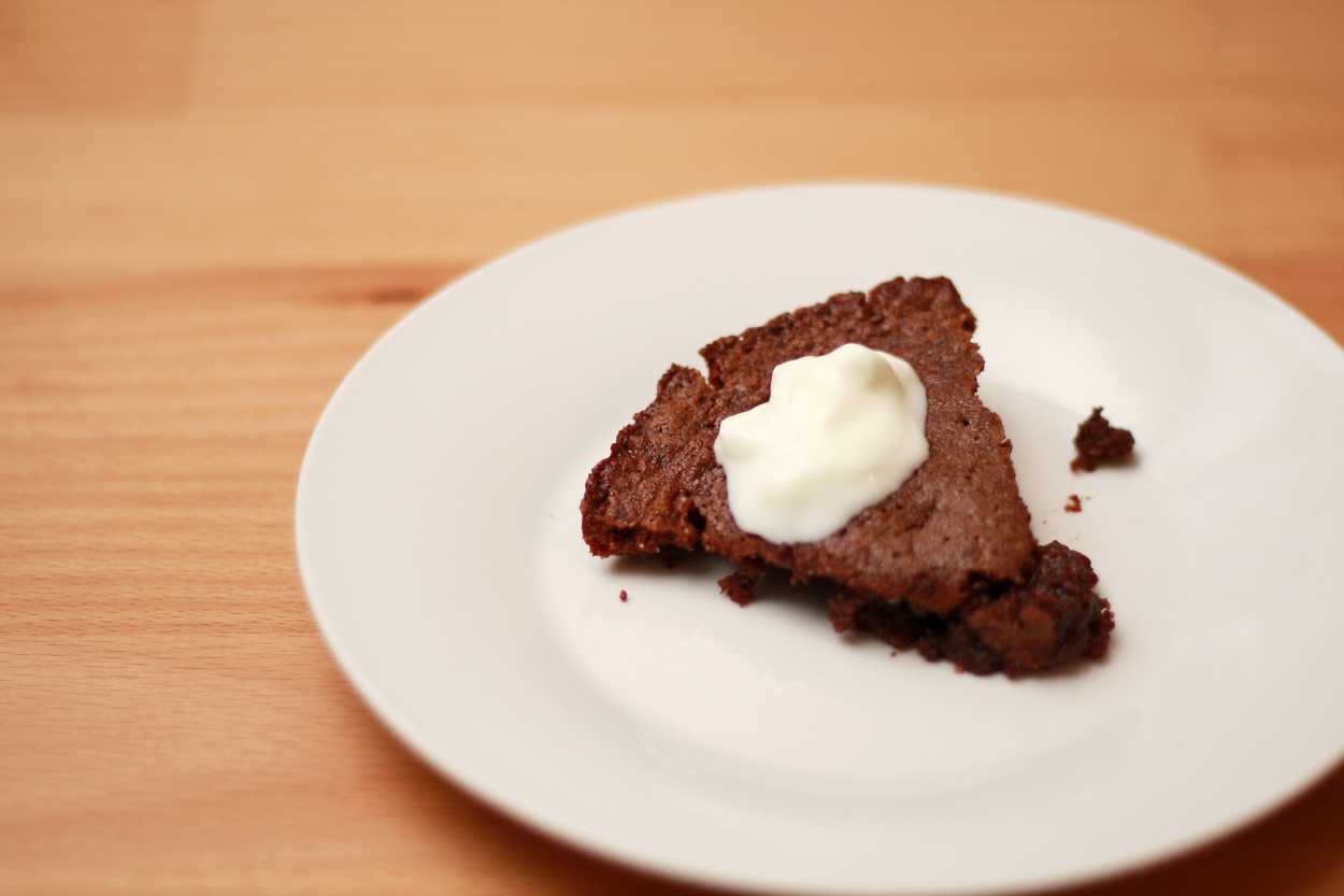 A sticky chocolate cake with whipped cream