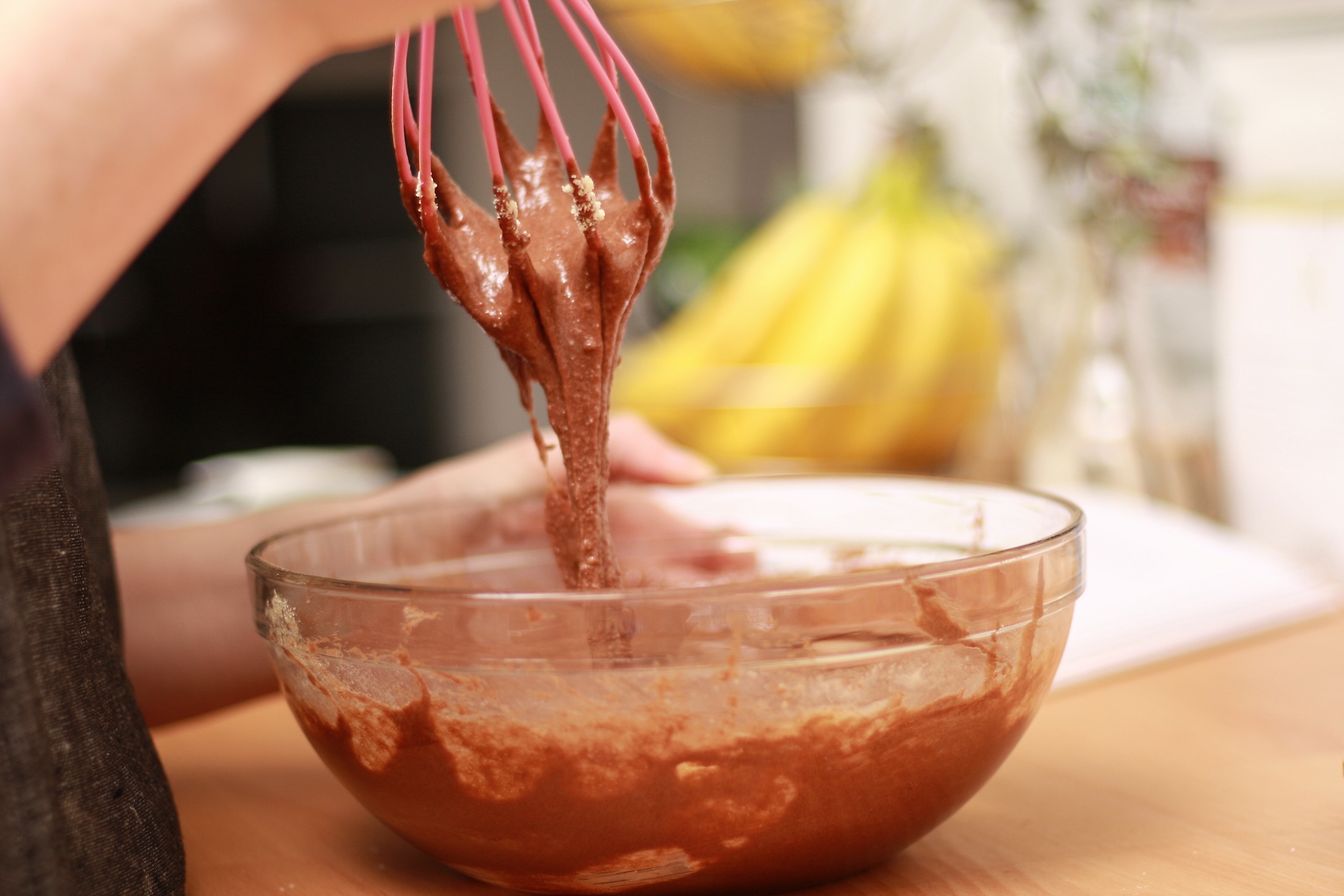 Alyssa whisks a cake batter until it's combined