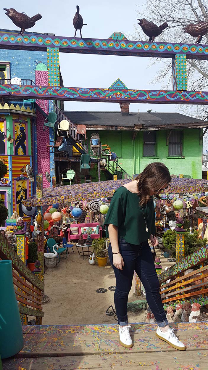 Alyssa stands on the colorful stairs at Randyland