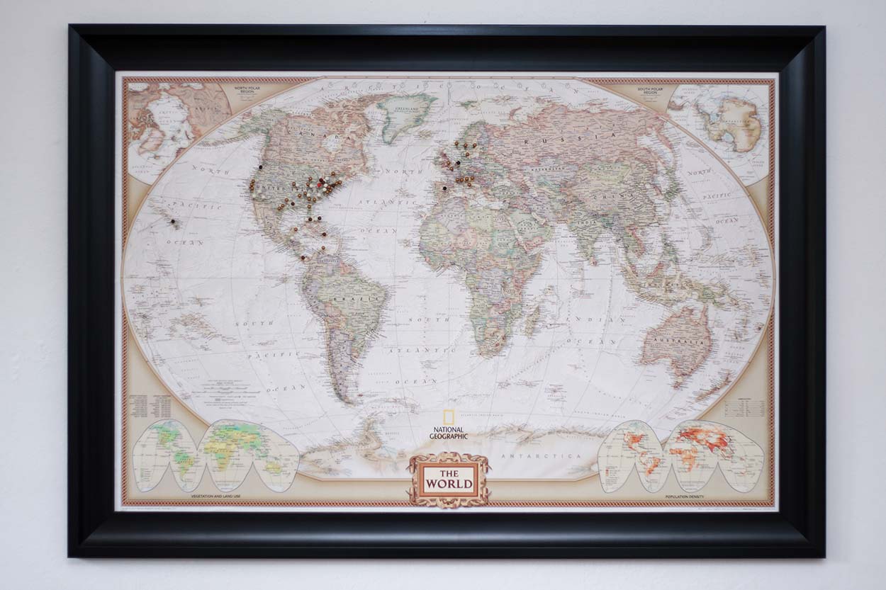 a DIY world pin map mounted on a wall