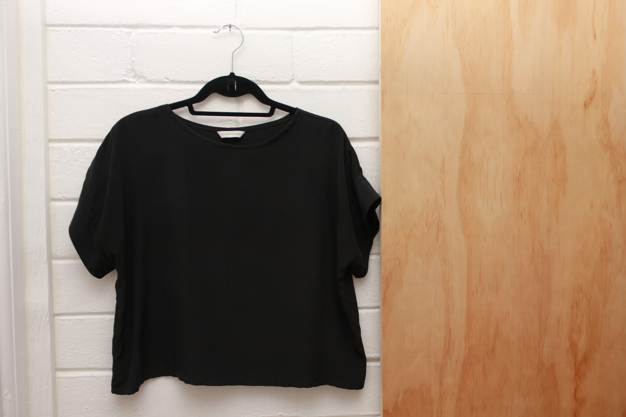 The Georgia Tee from Elizabeth Suzann hangs on a hanger