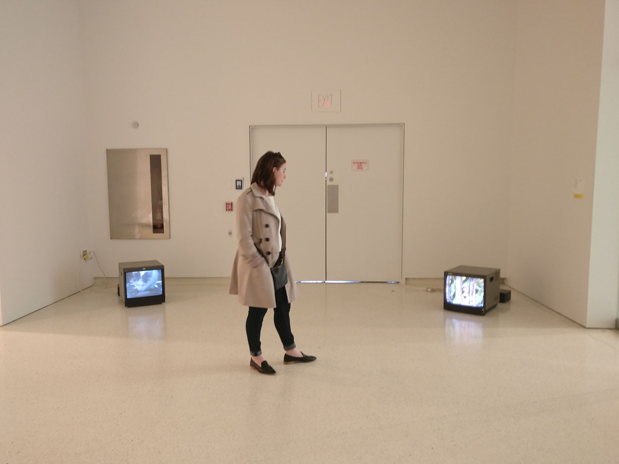 Alyssa stands in a room with old TVs at the Carnegie Museum of Art 