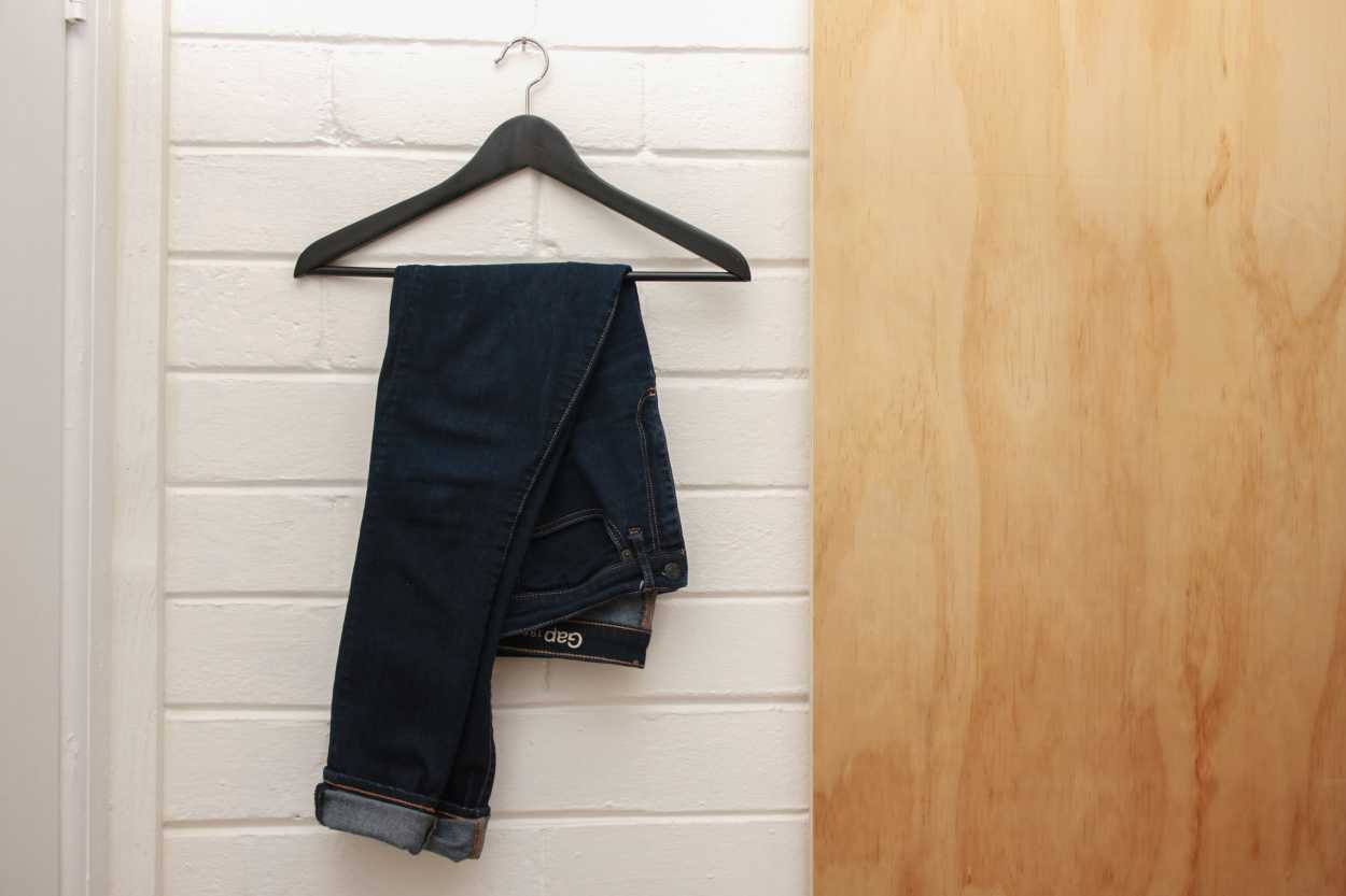 A pair of jeans from Gap hang on a hanger