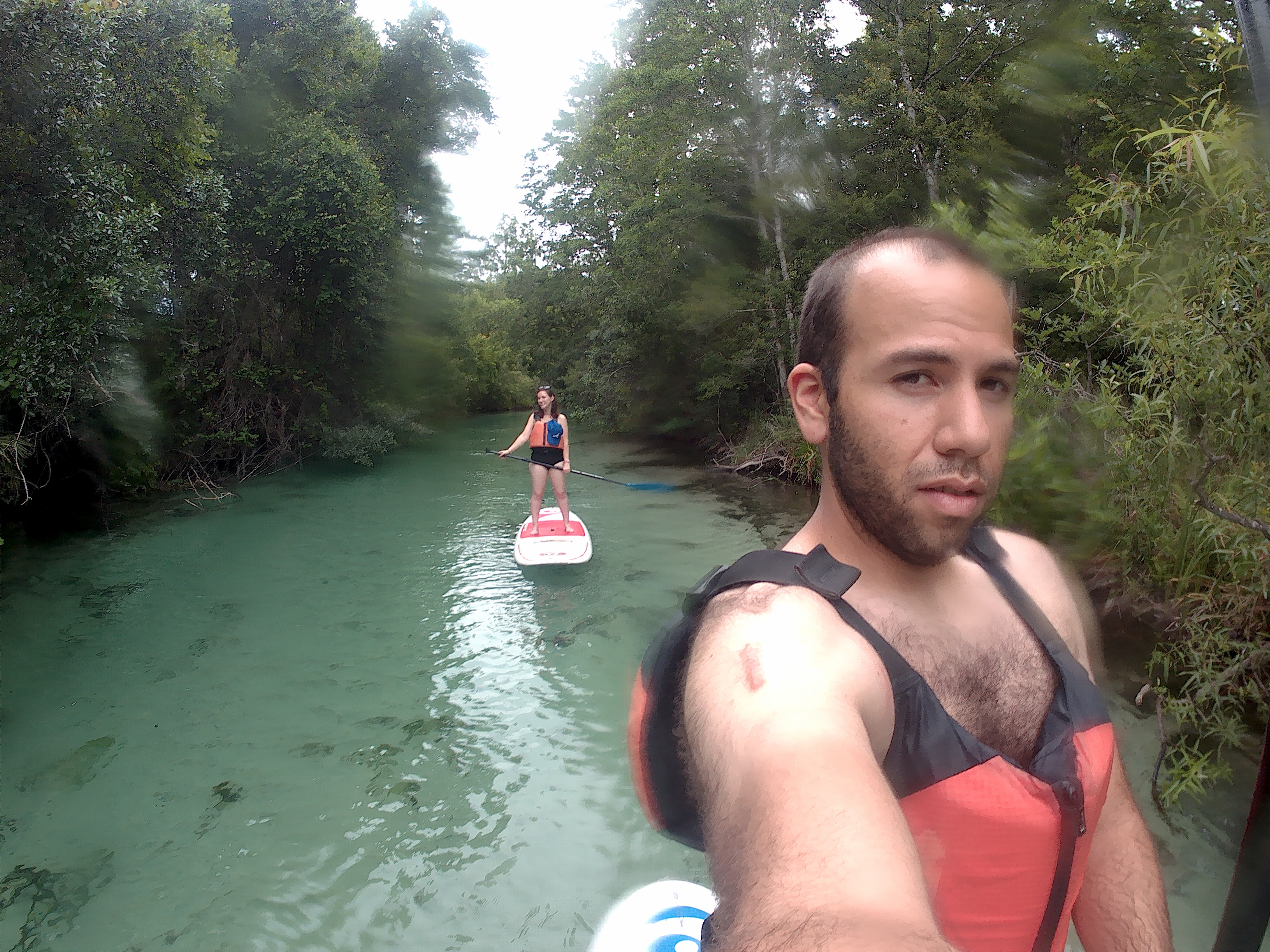 Alyssa and Michael paddleboard in the Weeki Wachee River