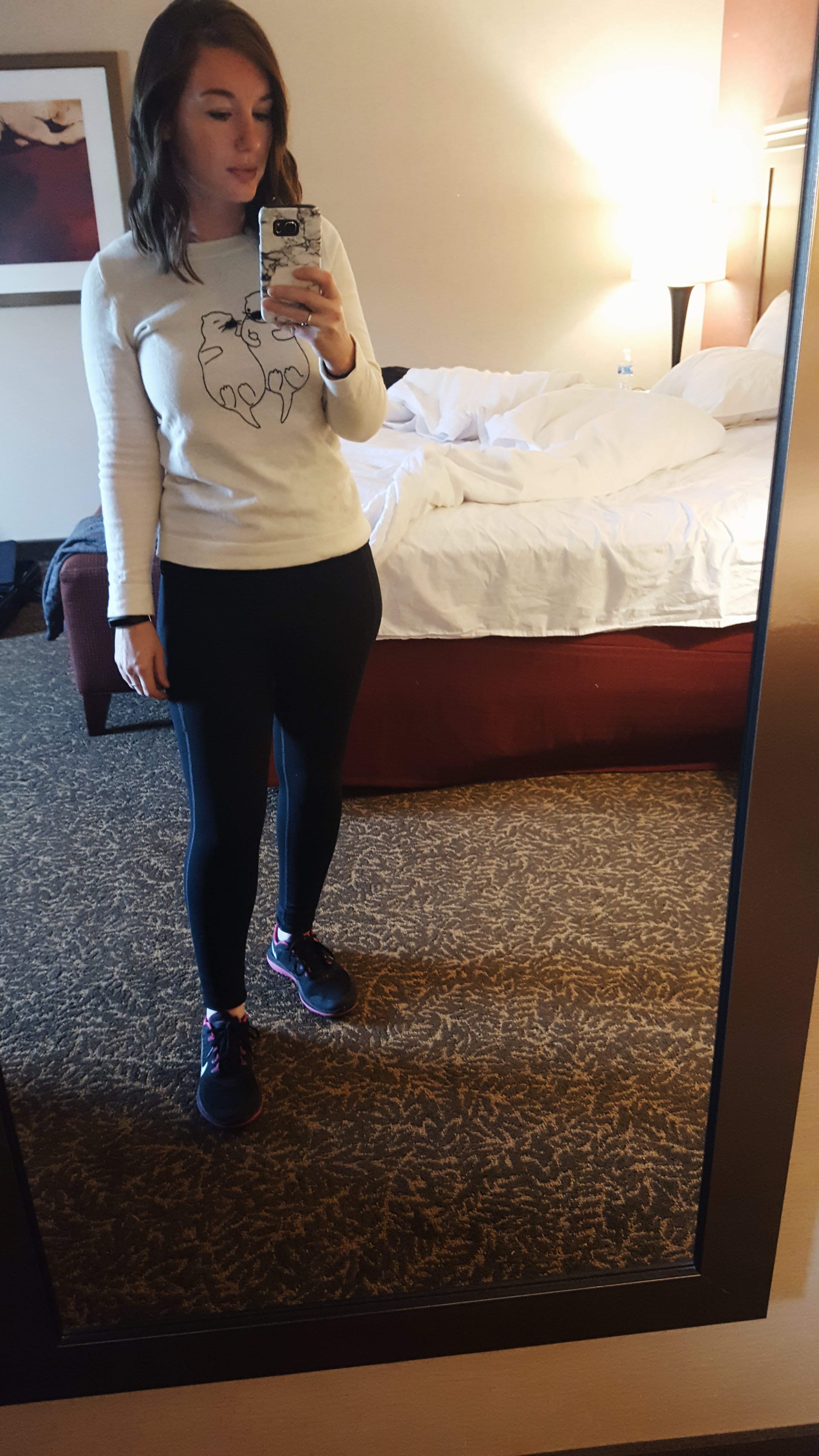 Alyssa wears an otter sweater with leggings and sneakers