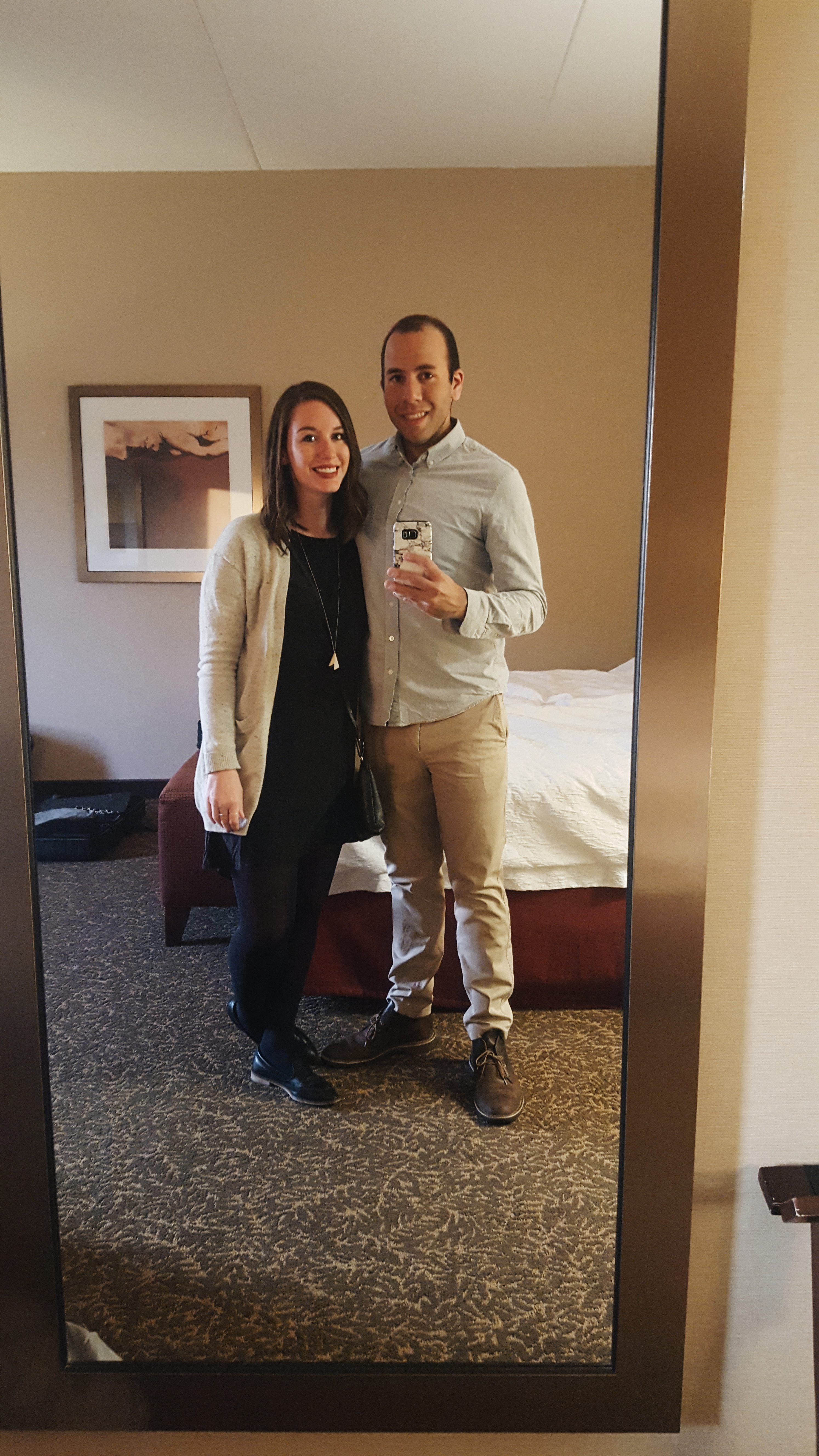 Alyssa and Michael are dressed up for dinner, taking a mirror selfie