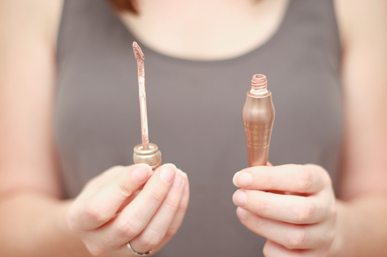 Alyssa holds a tube of eyeshadow primer