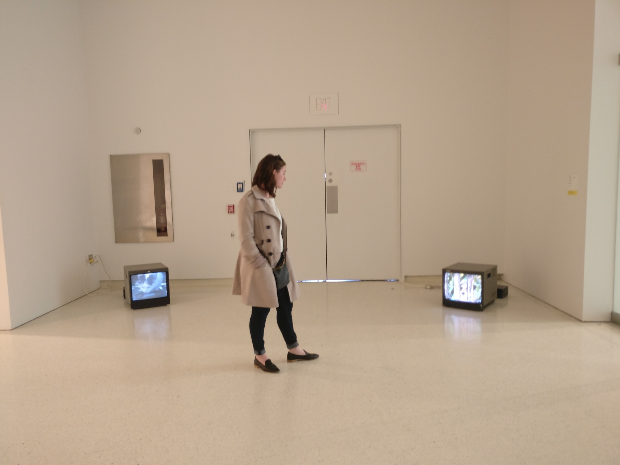 Alyssa stands in a room with old TVs at the Carnegie Museum of Art 