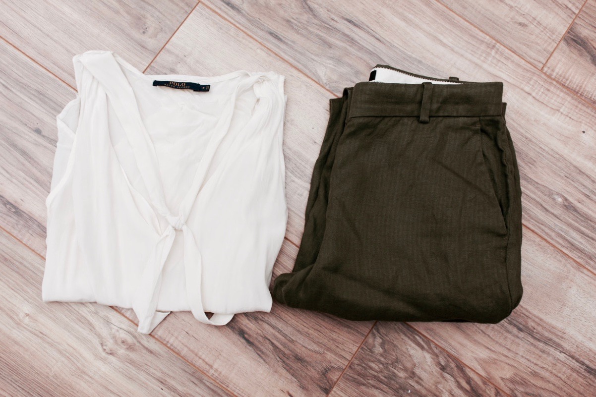 A white silk top and olive linen pants