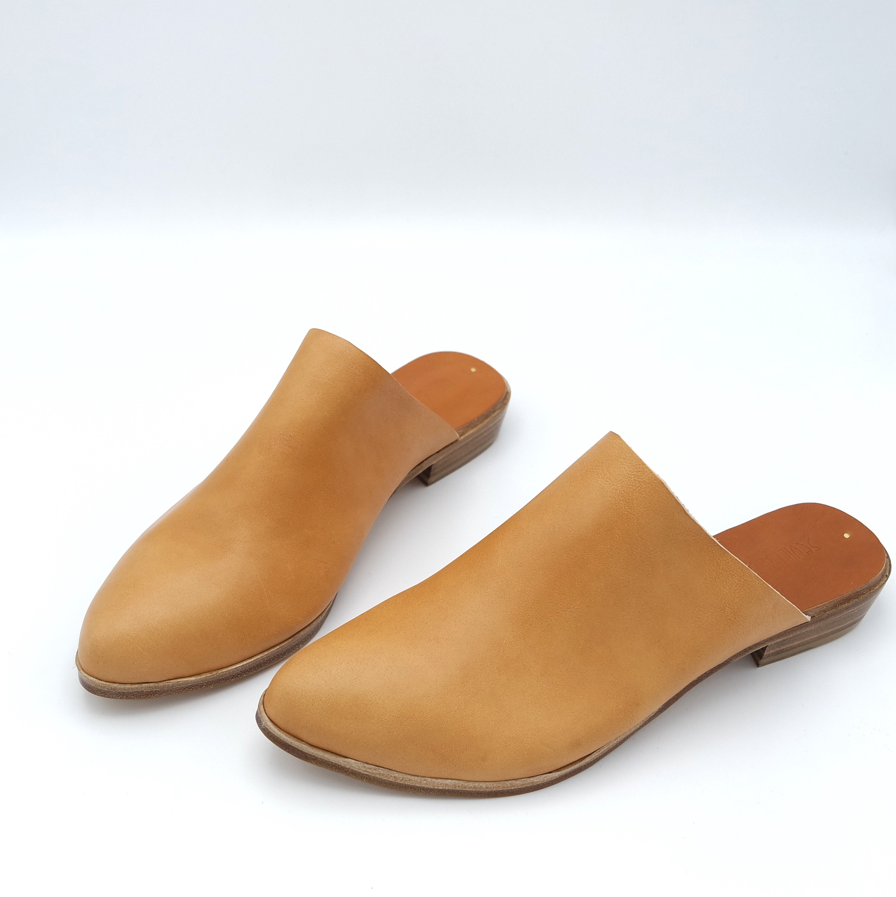 A pair of tan mules