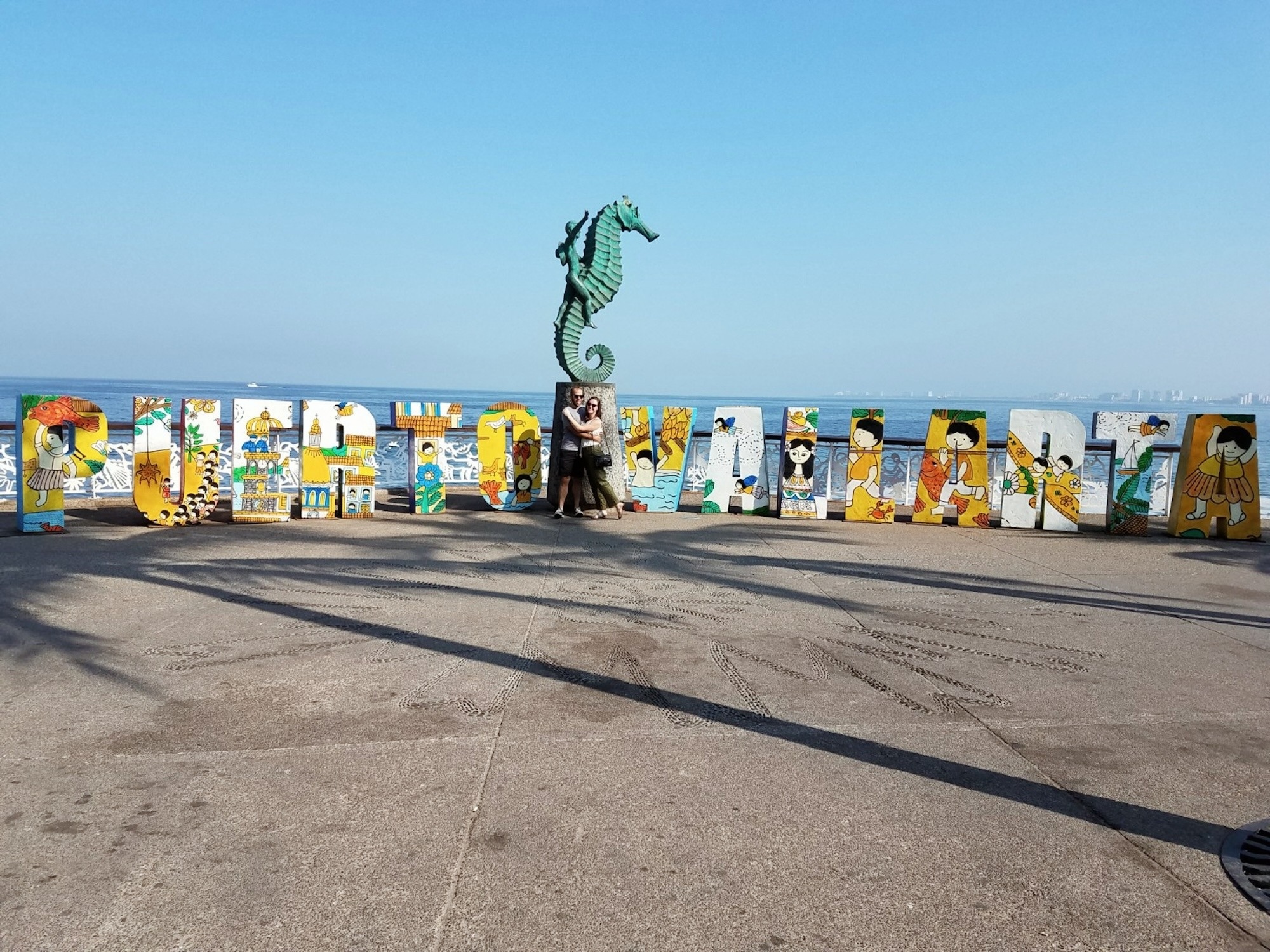 Alyssa and Michael take a photo at the famous Puerto Vallarta sign
