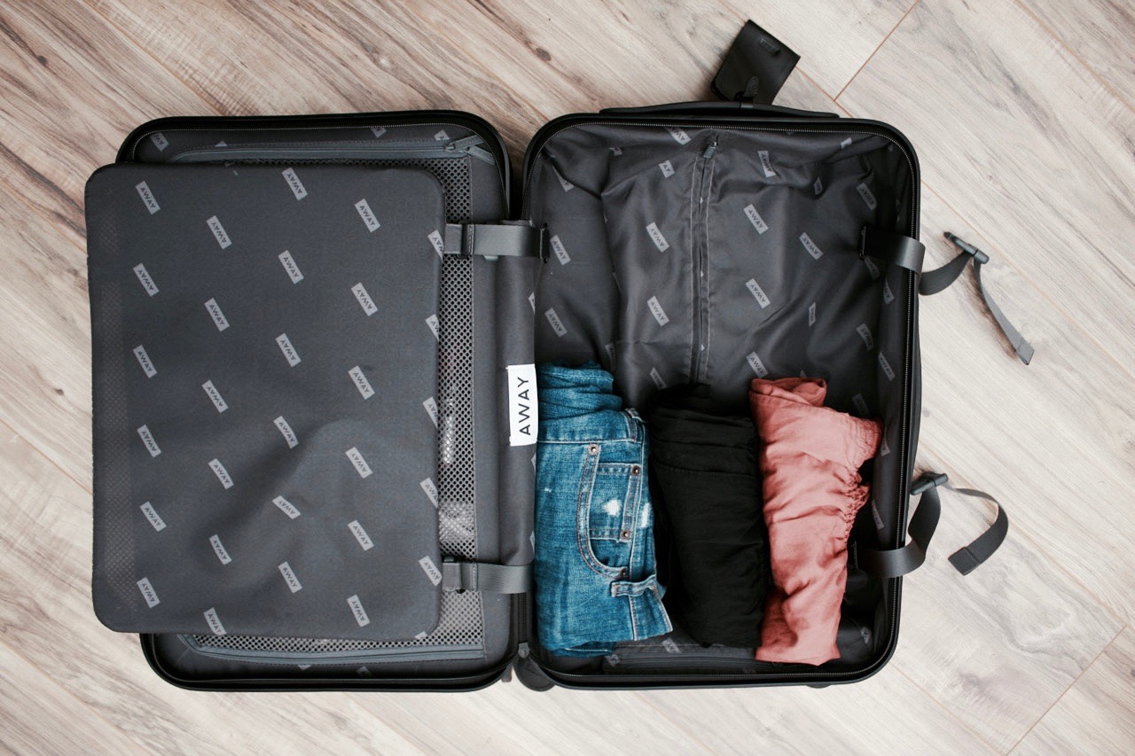 The Away Carry-On is partially packed with clothing