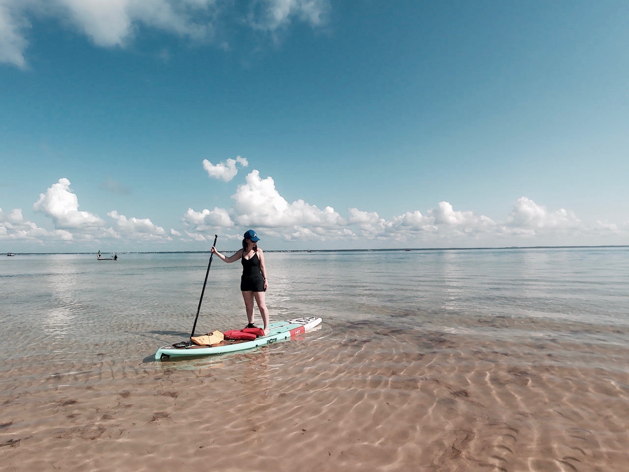 Alyssa stands on a SUP board in the Gulf of Mexico
