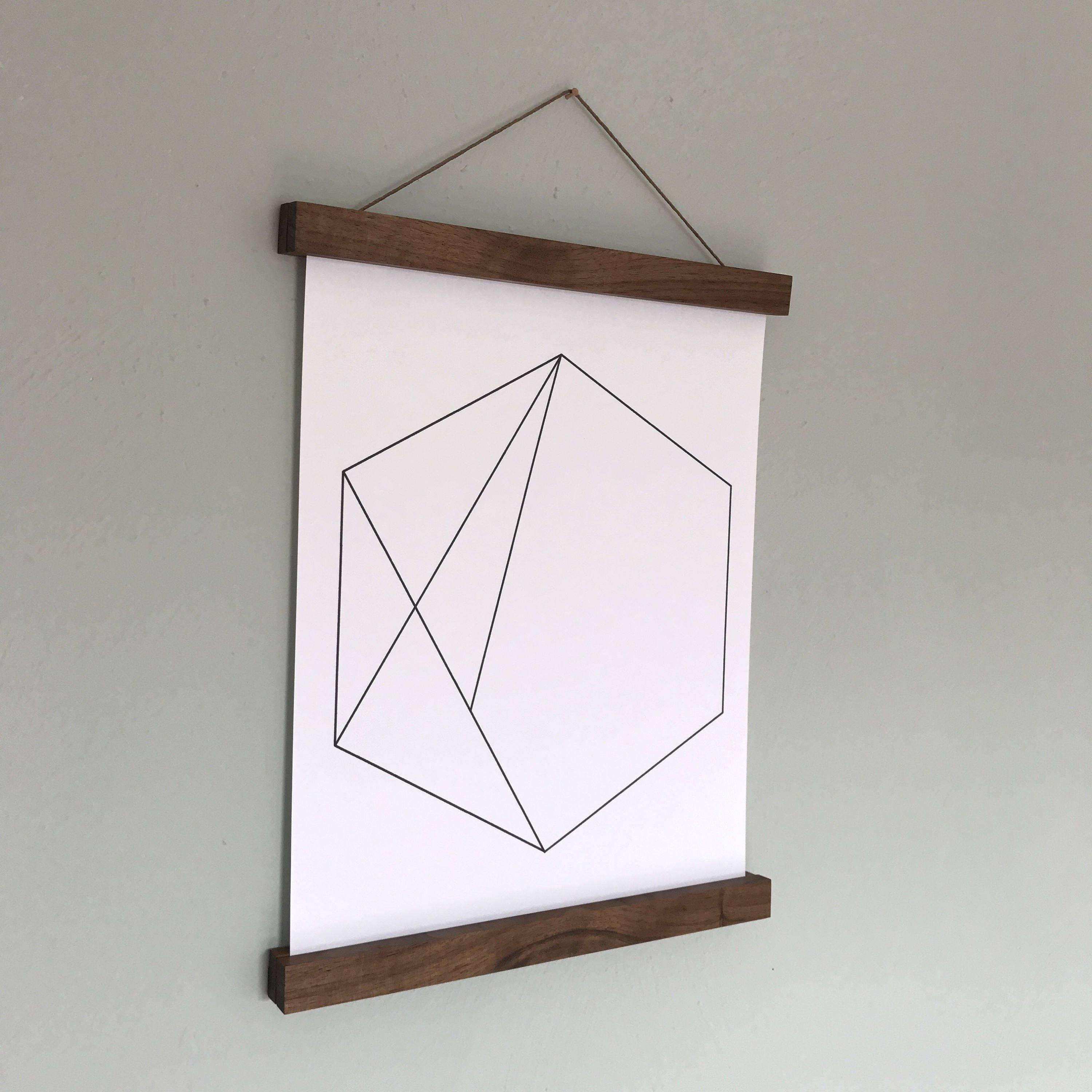 A wooden poster hanger frame with an abstract print
