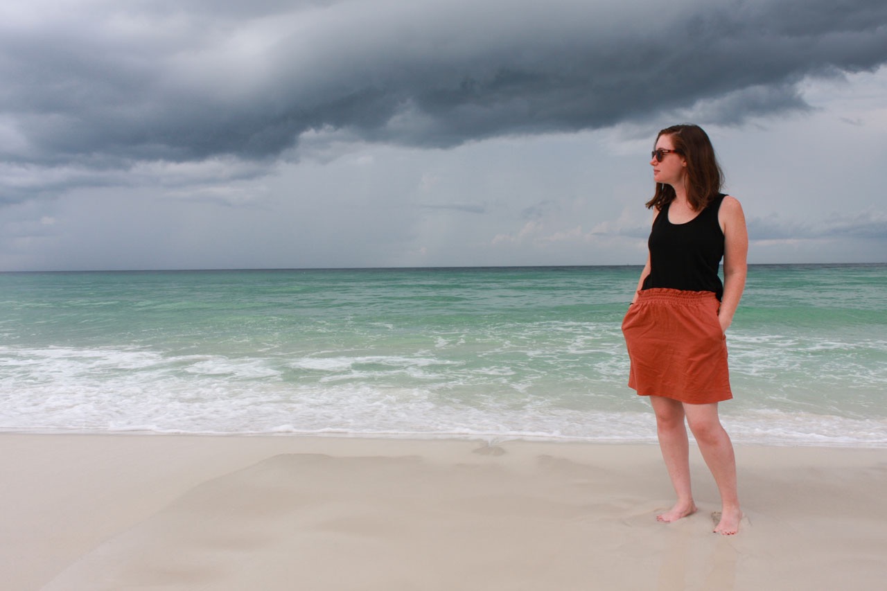 Alyssa stands on the beach in Miramar Beach 