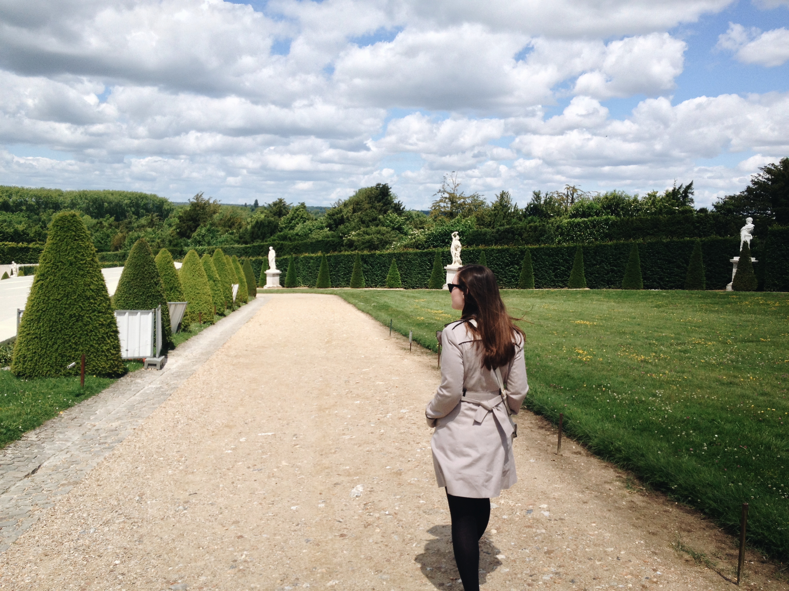 Alyssa walks through gardens at Versailles