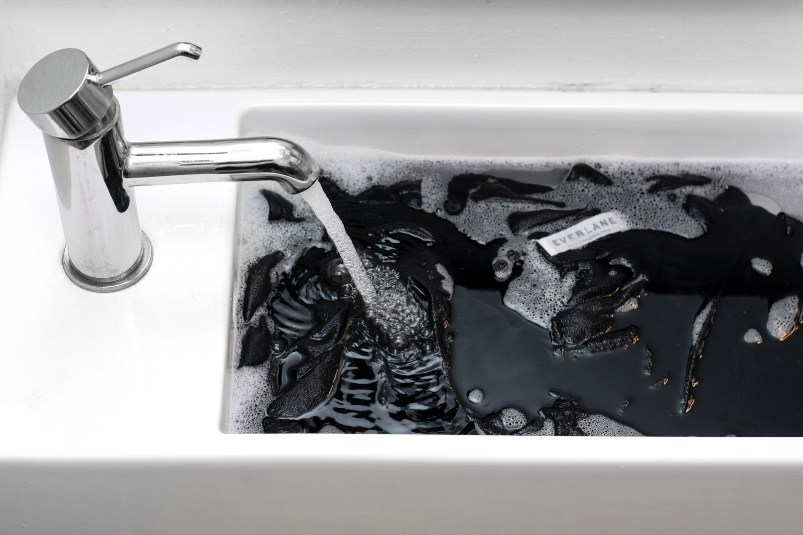 A silk dress from Everlane soaks in a sink