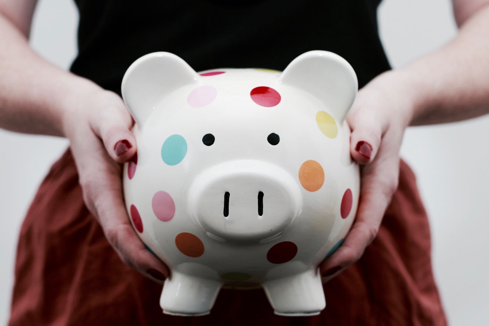 Alyssa holding a polka dot piggy bank