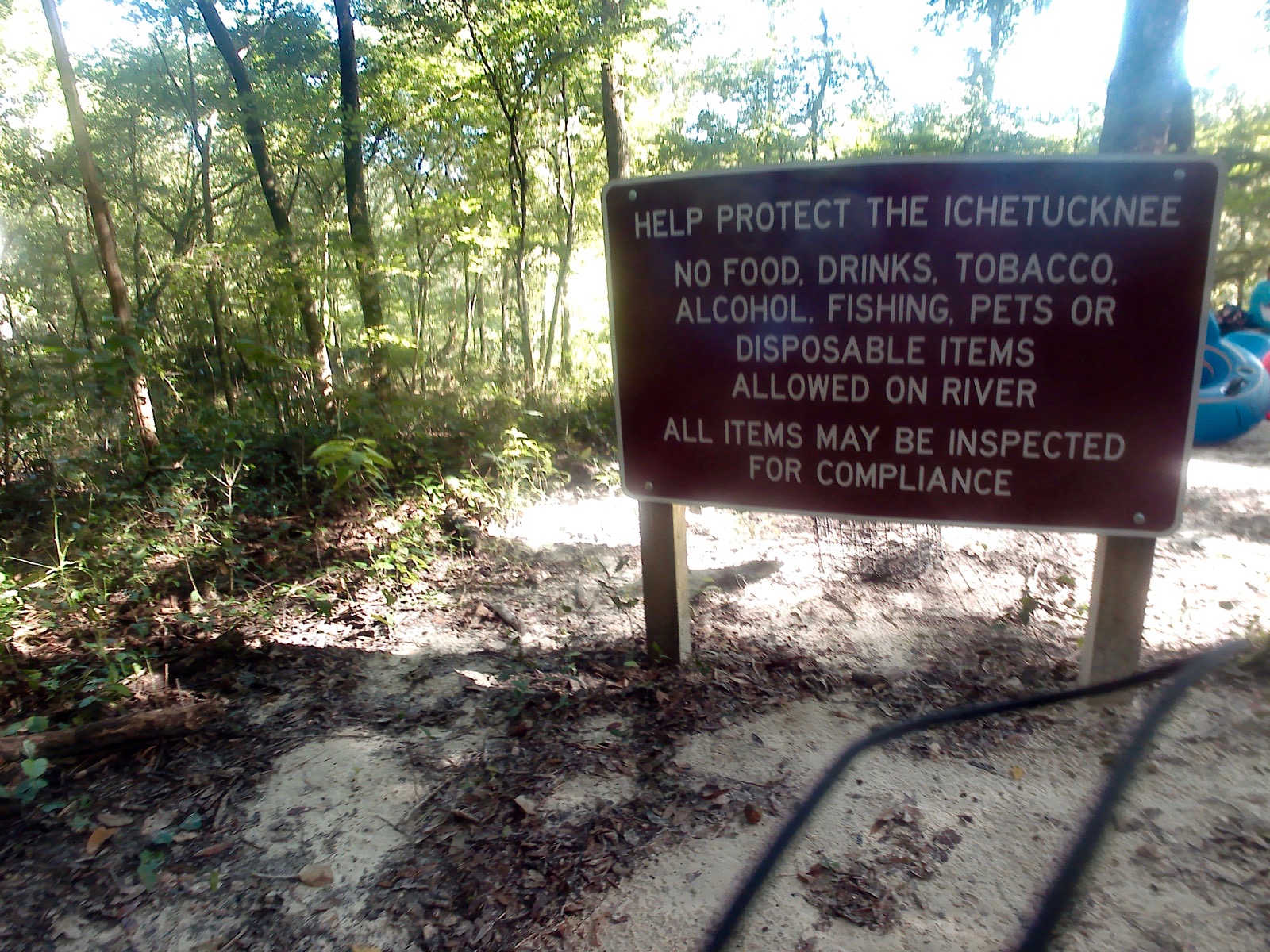 A sign instructing tubers to protect the river