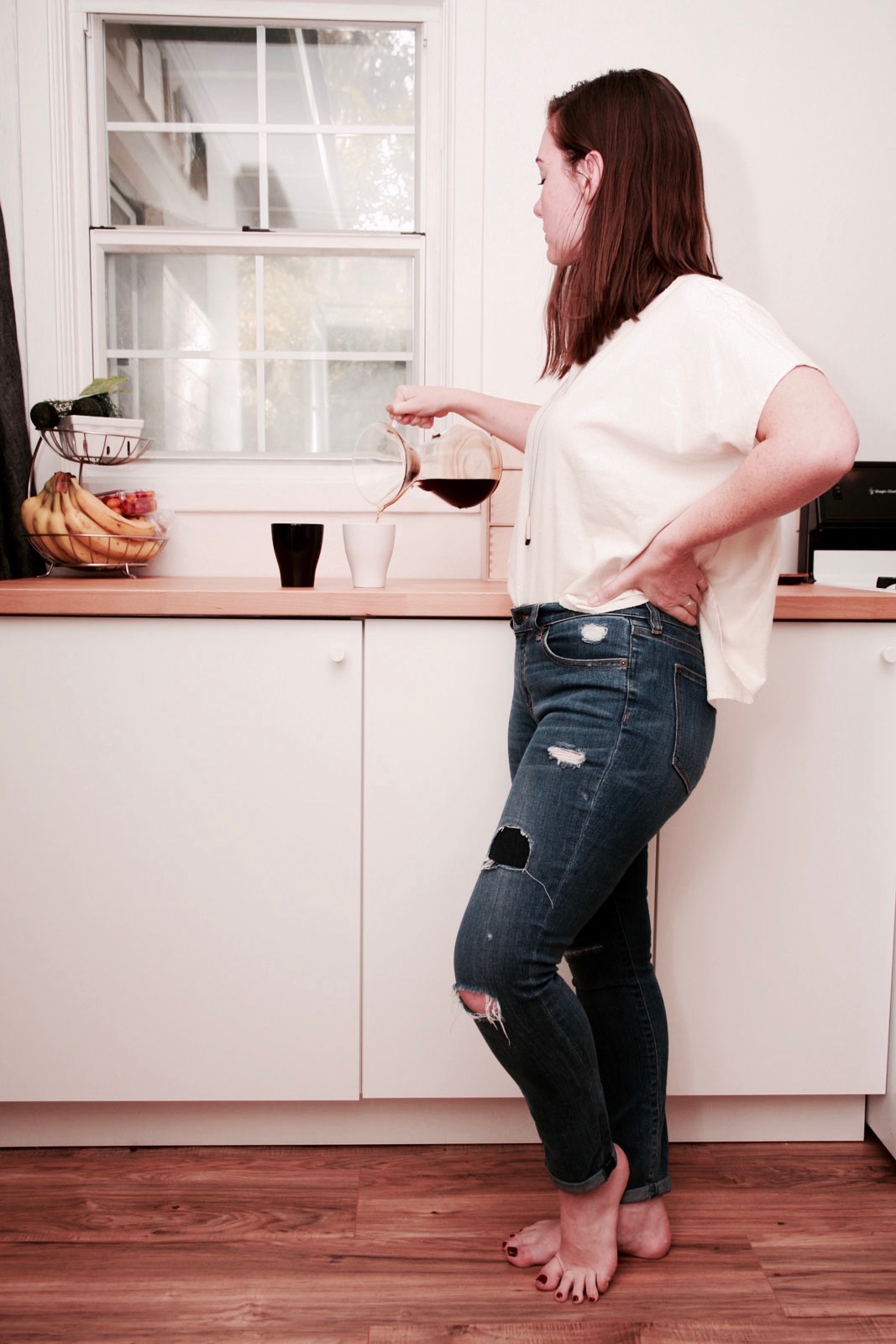 Alyssa pours coffee from a Chemex to mugs