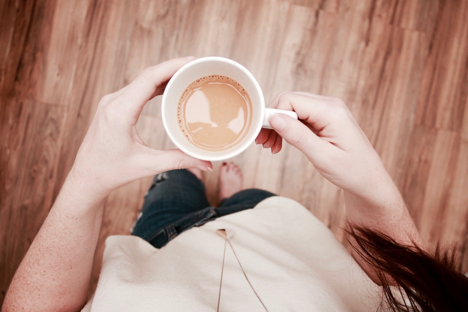 Alyssa holds a cup of coffee in this top down photo