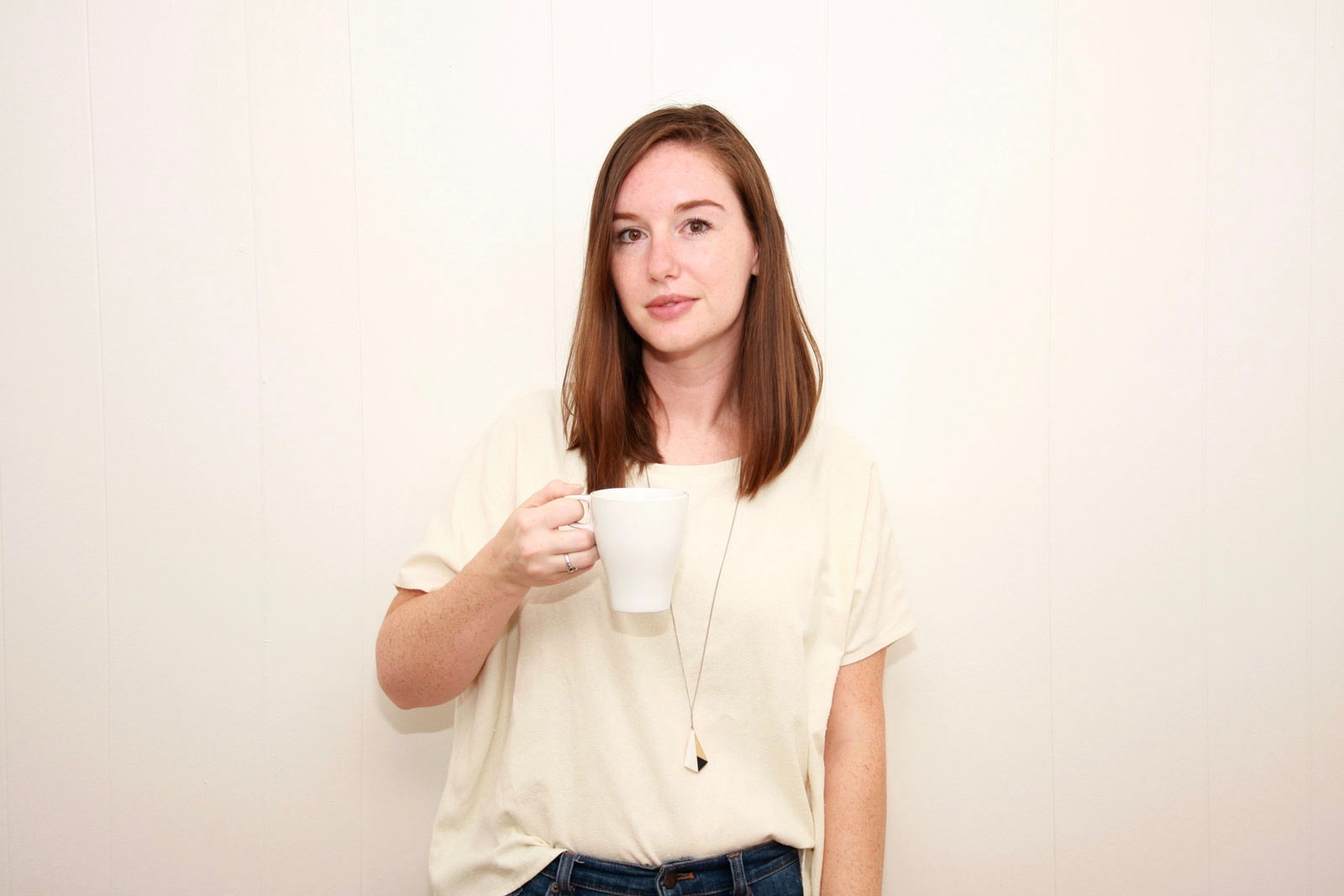 Alyssa holds a mug of coffee