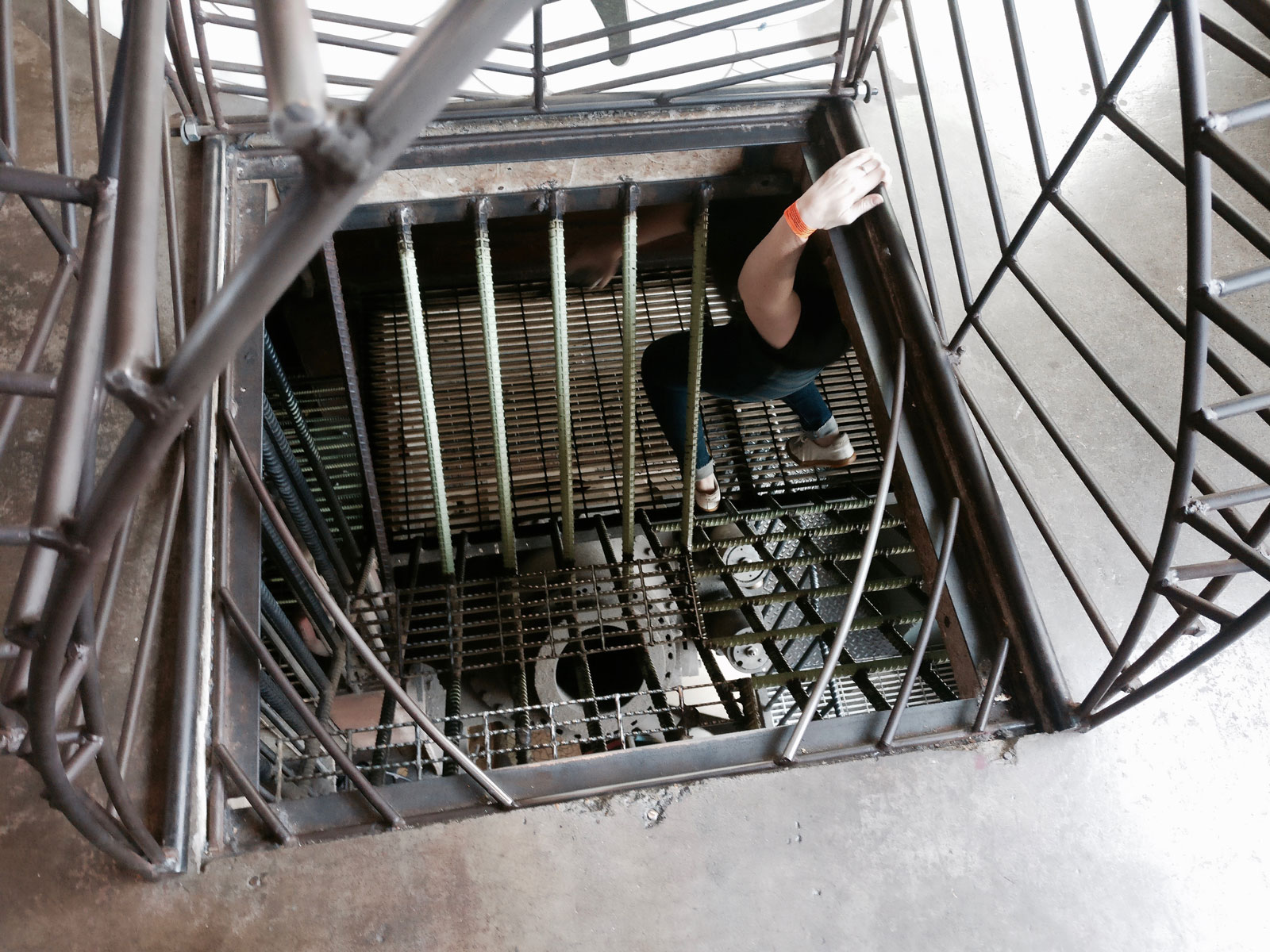Alyssa climbs down a fire-escape type of staircase at the City Museum