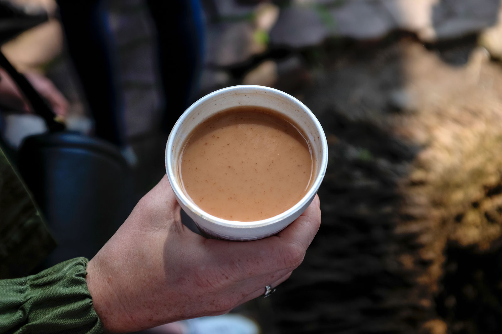 Alyssa holds a cup of Champurrado