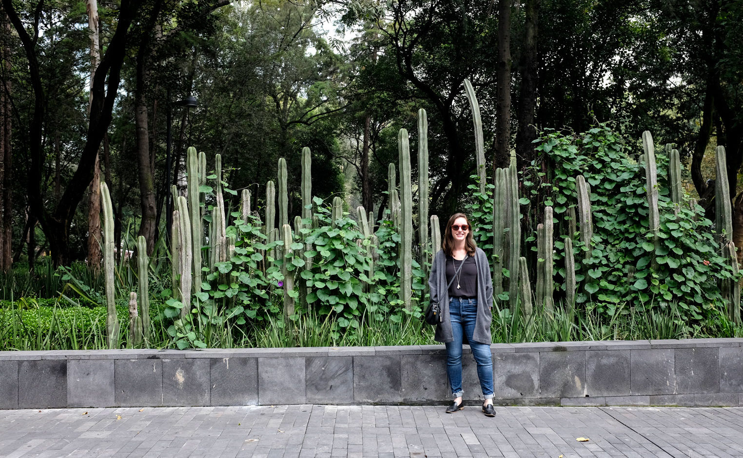 Alyssa stands with a row of cacti in Mexico City