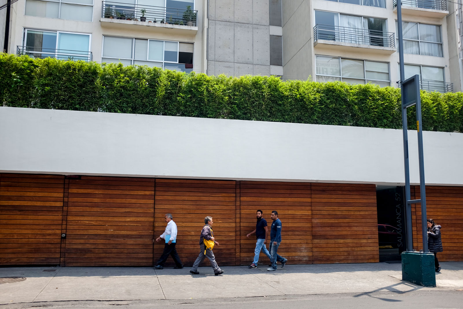 People walking down a Mexico City Sidewalk