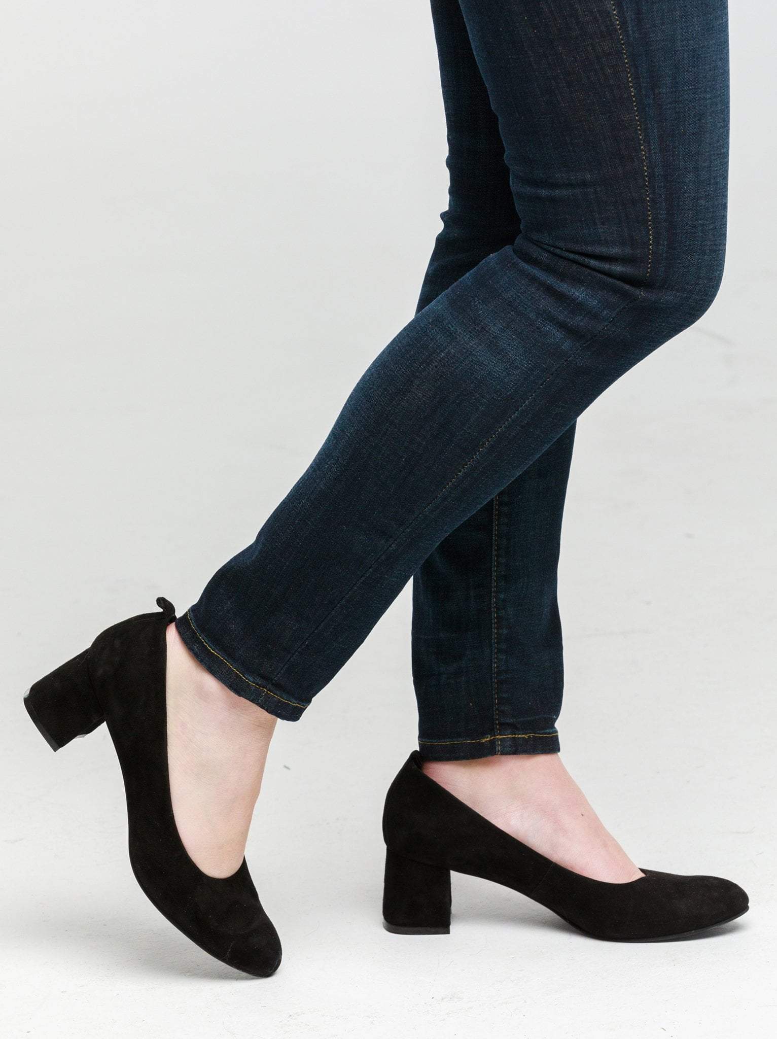 A pair of black block heels in suede