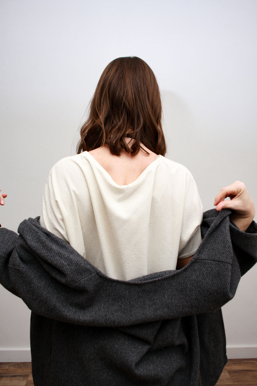 Alyssa slouches a wool cardigan off her shoulders