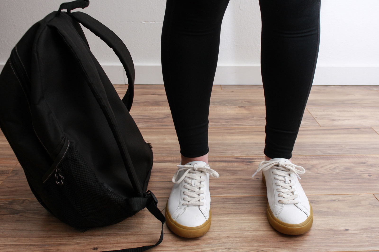 A closeup of Alyssa's leg in the Girlfriend Leggings and Veja Sneakers