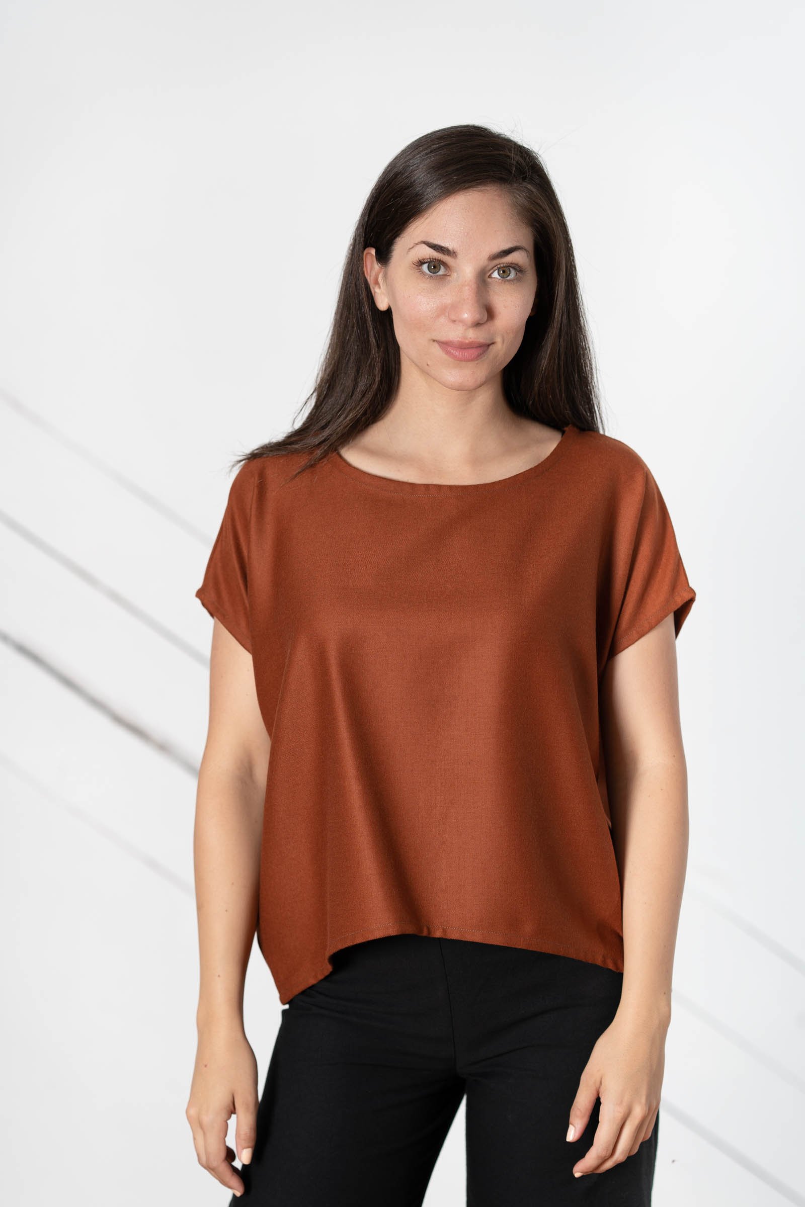 A woman in a rust oversized tee