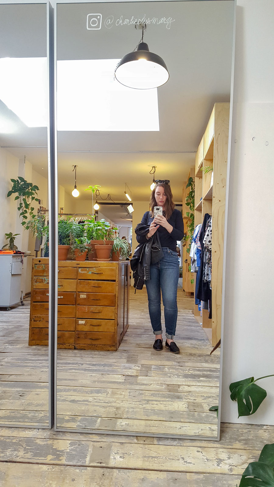 Alyssa takes a mirror selfie in front of Charlie + Mary