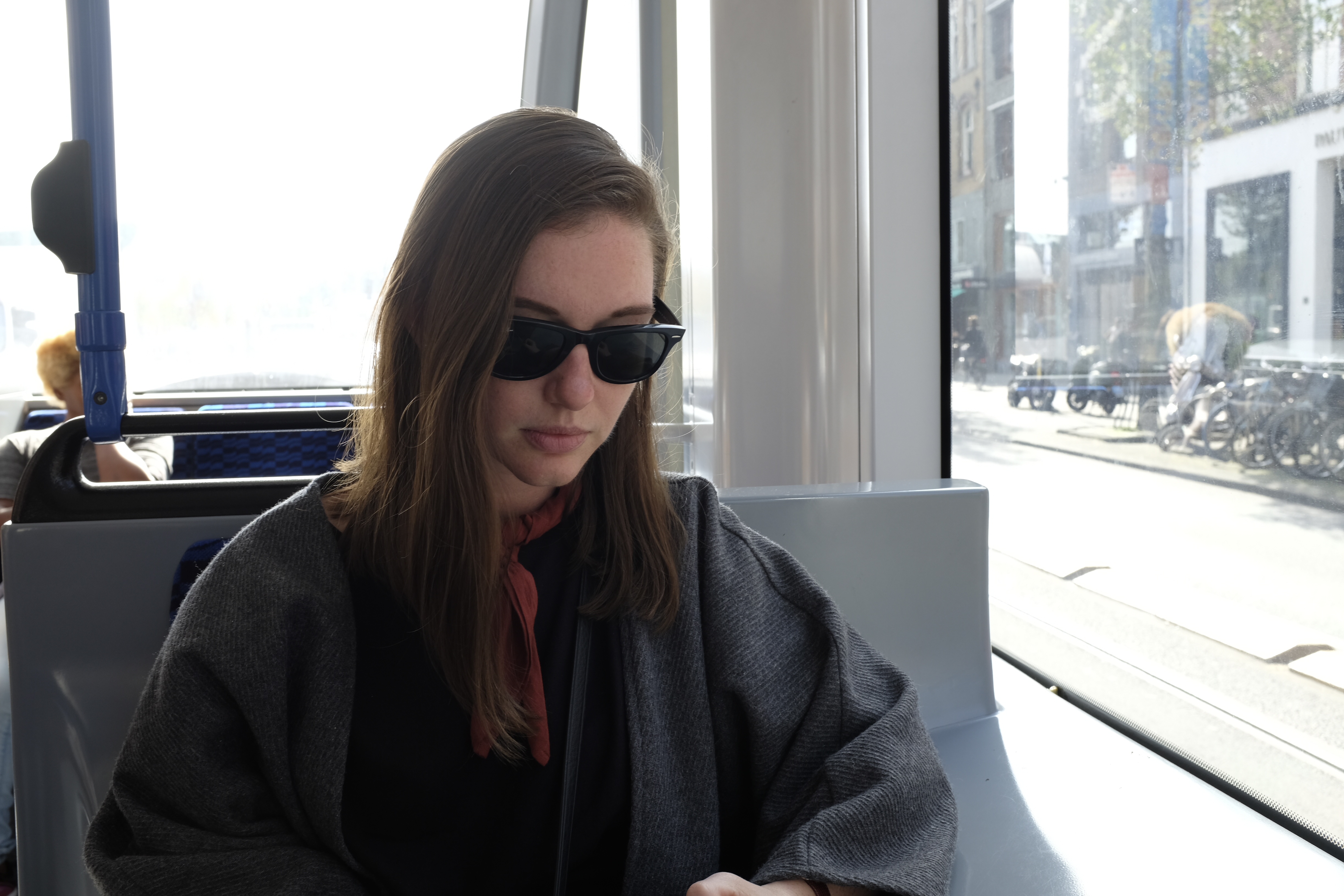 Alyssa sits on a tram car in Amsterdam