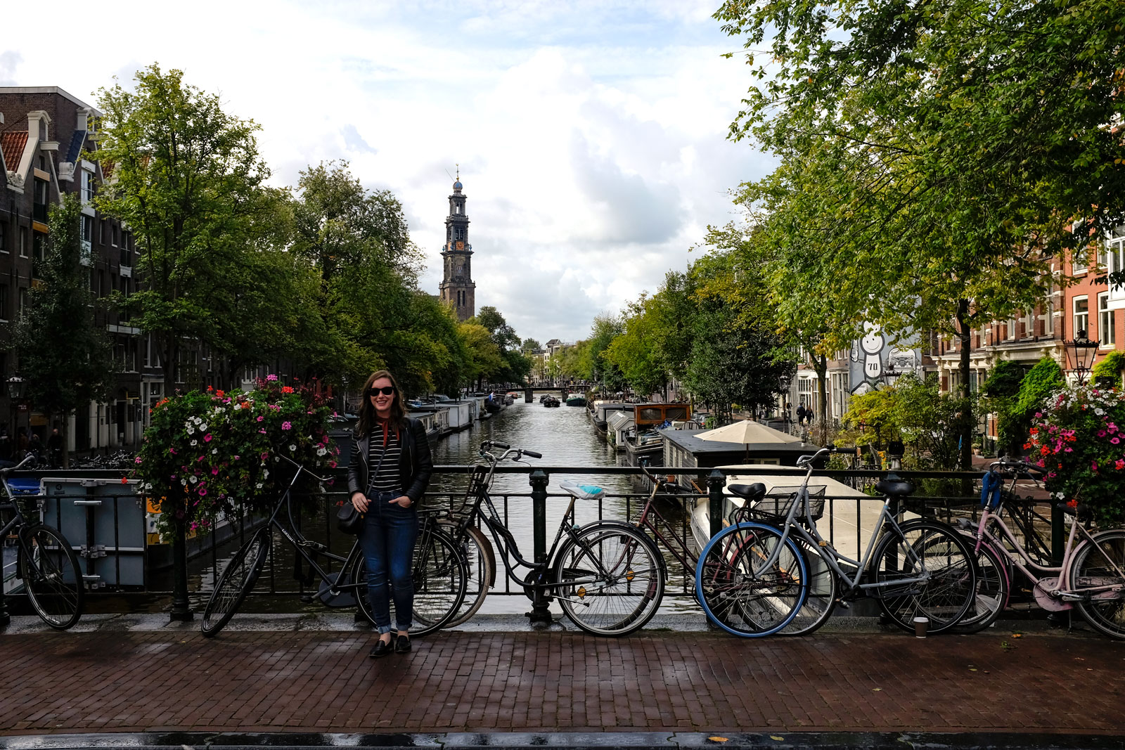 Alyssa stands near bicycles along a canal in Amsterdam