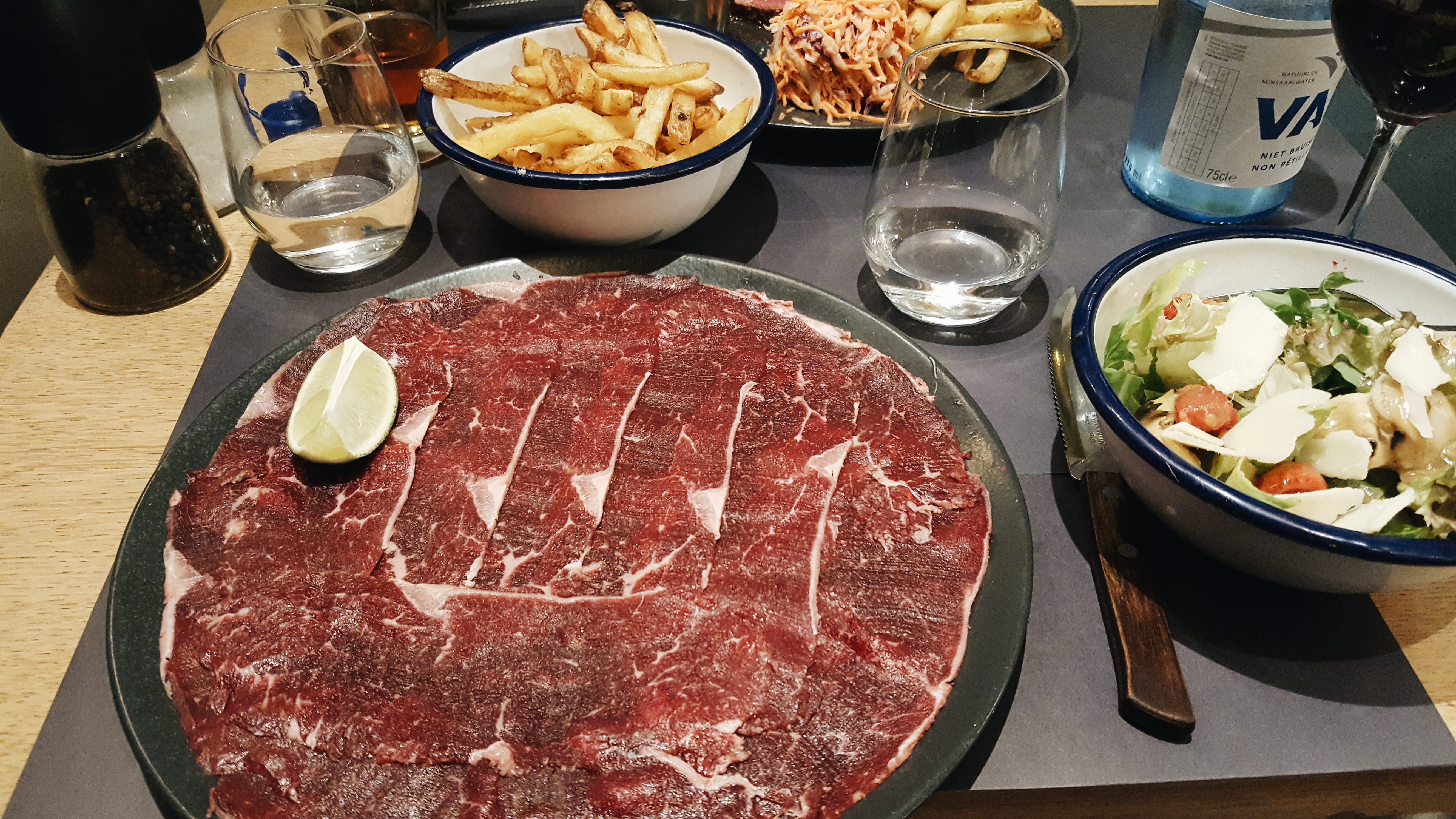 A plate meat, a salad, and fries at La Meute in Brussels