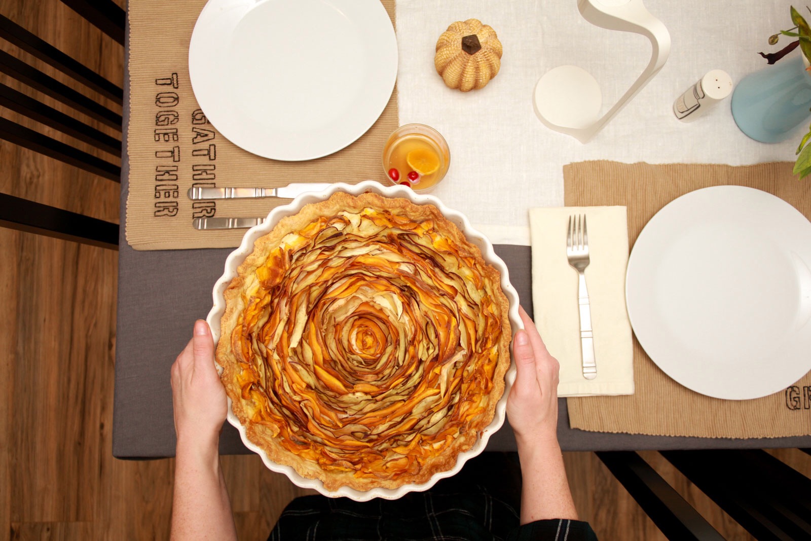 Alyssa sets a vegetable tart down on the Thanksgiving Table