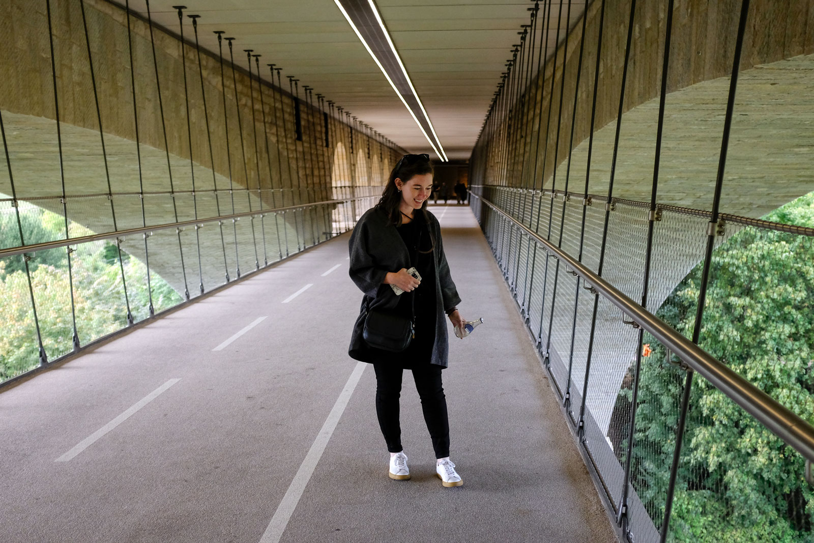 Alyssa stands on the pedestrian walkway on the Pont Adolphe in Luxembourg