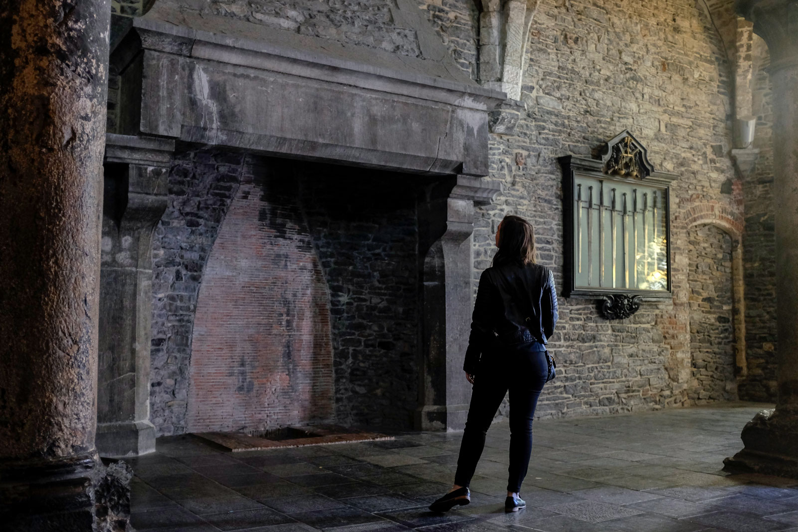 Alyssa examines a fireplace at Gravensteen