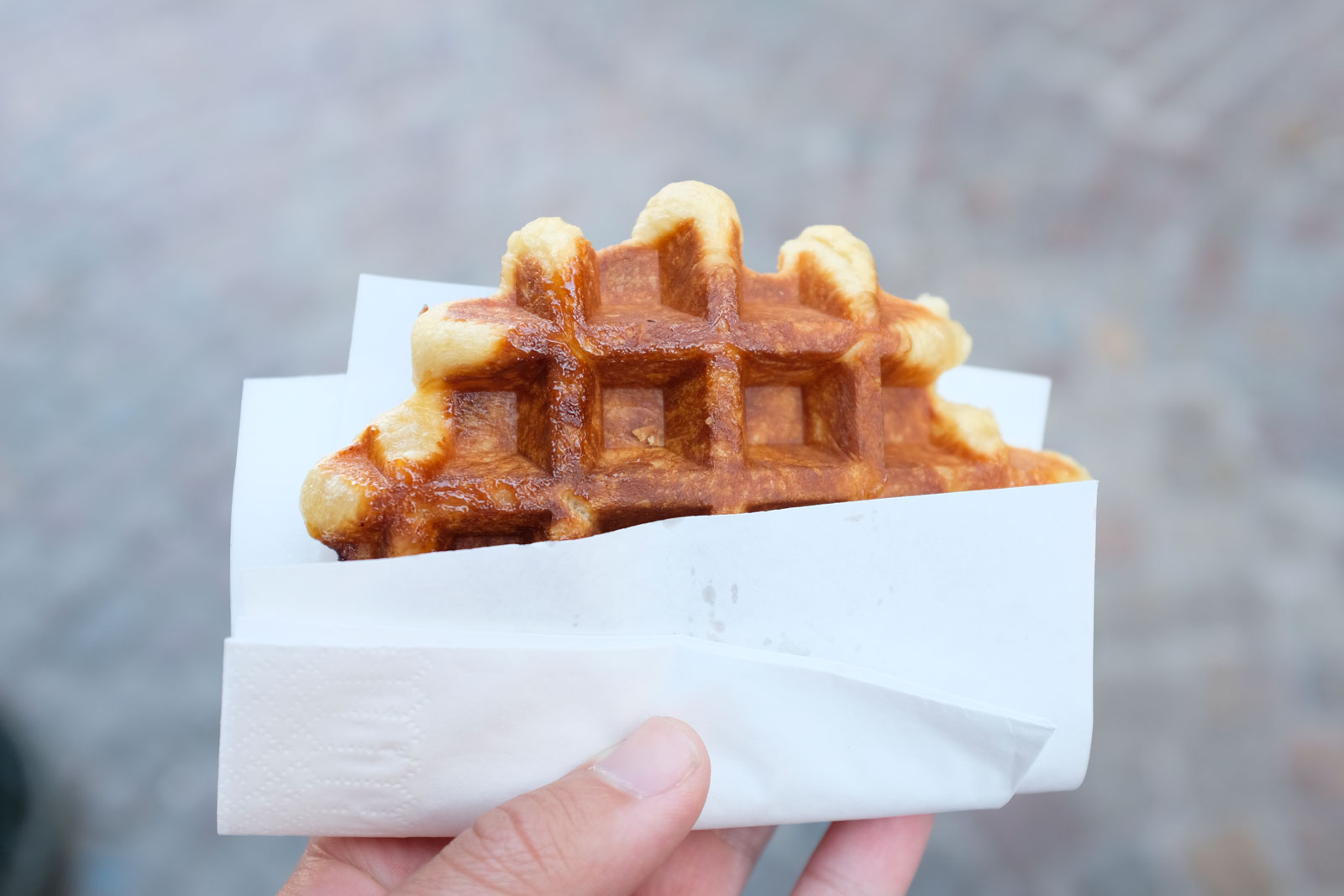 Michael holds a waffle from Chez Albert