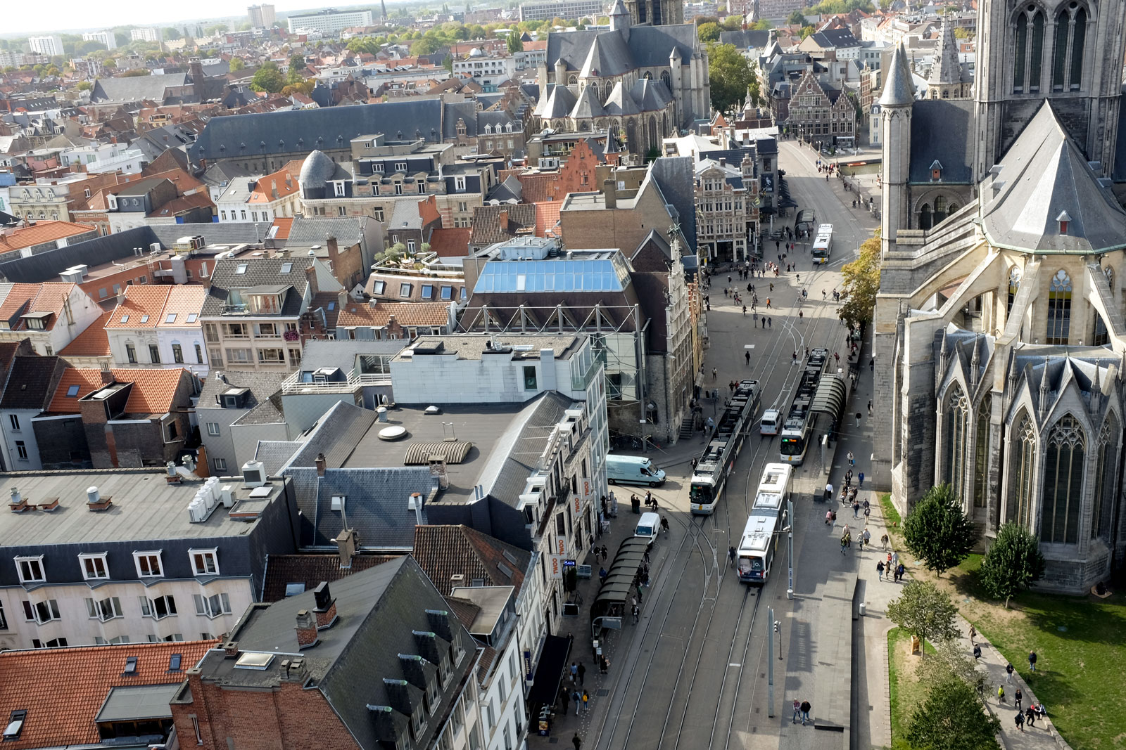 View of trams and city streets below taken from the Ghent Belfry