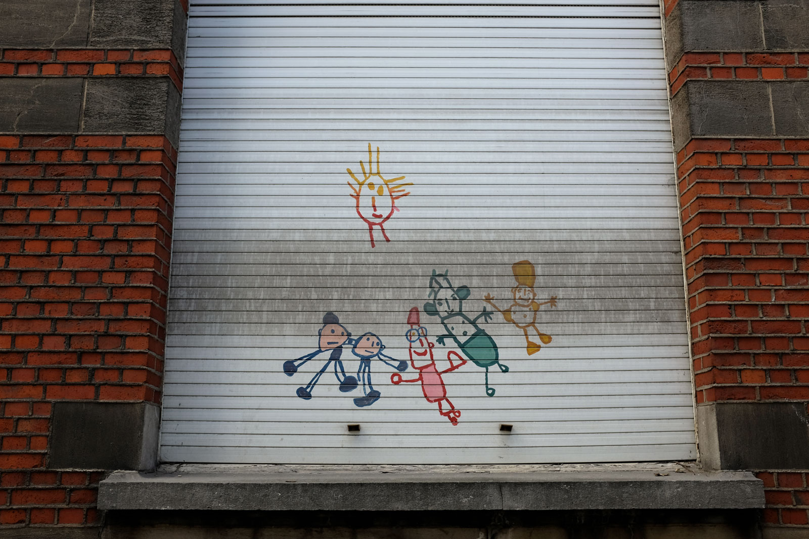 Graffiti in Antwerp with children and a sun