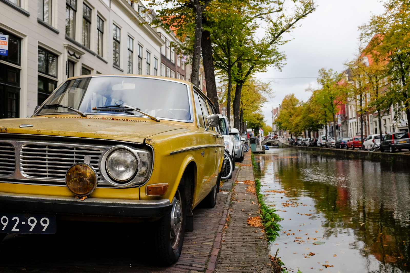 Cars parked along the canal in Delft