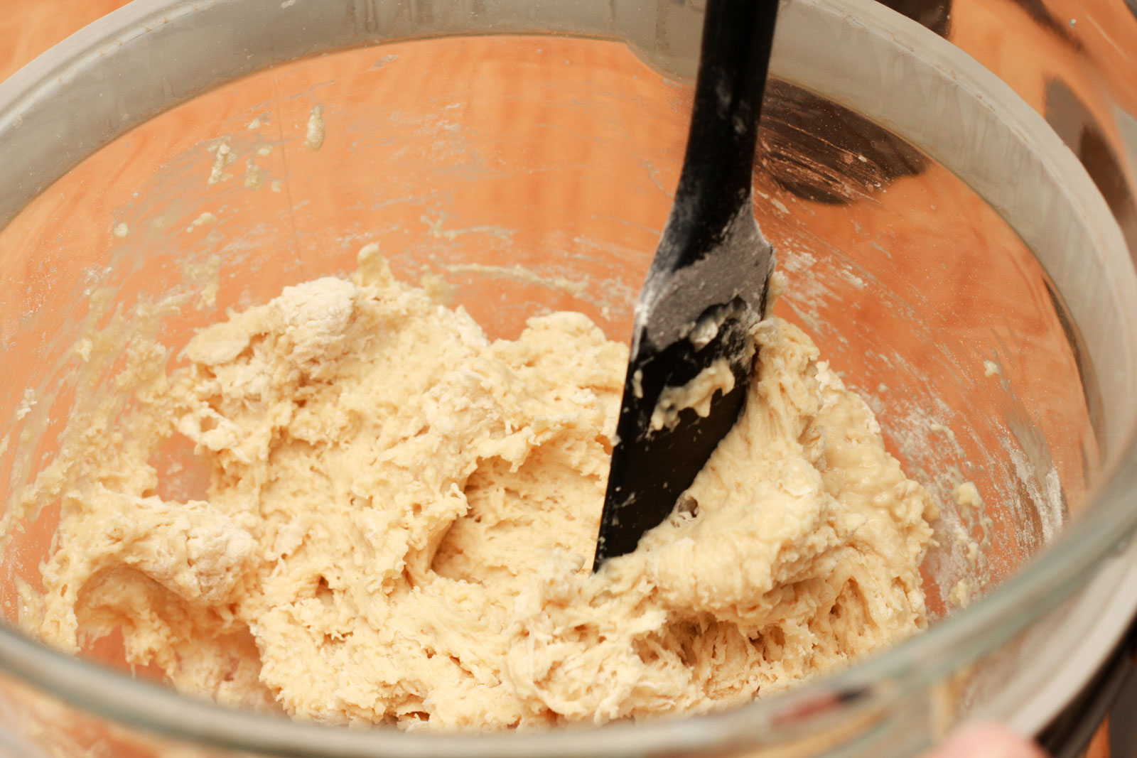 Alyssa stirs the liege waffle dough with a spatula